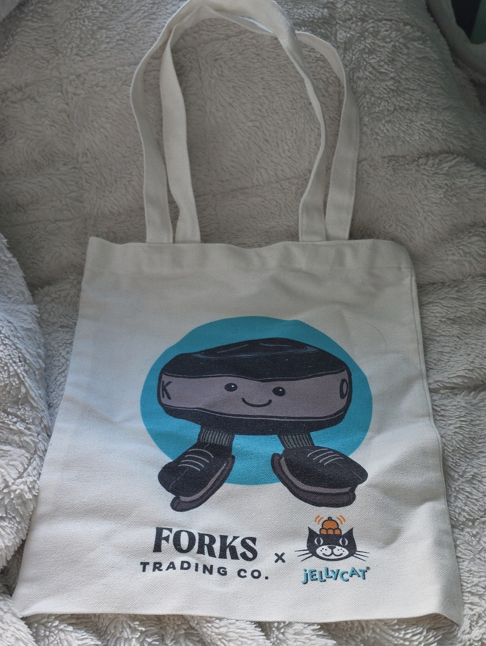Jellycat Cream Tote Bag with Teal and Black Hockey Puck Graphic